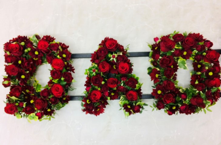 <h2>DAD Funeral Letters | Funeral Flowers</h2>
<ul>
<li>Approximate Size W 90cm H 30cm</li>
<li>Hand created DAD tribute letter in red and green</li>
<li>To give you the best we may occasionally need to make substitutes</li>
<li>Funeral Flowers will be delivered at least 2 hours before the funeral</li>
<li>For delivery area coverage see below</li>
</ul>
<h2><br />Liverpool Flower Delivery</h2>
<p>We have a wide selection of Funeral Tributes offered for Liverpool Flower Delivery. Funeral Tributes can be provided for you in Liverpool, Merseyside and we can organize Funeral flower deliveries for you nationwide. Funeral Flowers can be delivered to the Funeral directors or a house address. They can not be delivered to the crematorium or the church.</p>
<br>
<h2>Flower Delivery Coverage</h2>
<p>Our shop delivers funeral flowers to the following Liverpool postcodes L1 L2 L3 L4 L5 L6 L7 L8 L11 L12 L13 L14 L15 L16 L17 L18 L19 L24 L25 L26 L27 L36 L70 If your order is for an area outside of these we can organise delivery for you through our network of florists. We will ask them to make as close as possible to the image but because of the difference in stock and sundry items, it may not be exact.</p>
<br>
<h2>Liverpool Funeral Flowers | Letters</h2>
<p>A classic DAD Funeral Tribute covered with roses and spray chrysanthemums in red, edged with green foliage.</p>
<br>
<p>Name Funeral Tributes or Letter Funeral Flowers are a way to create a tribute that is truly unique and specially designed for a loved one.</p>
<br>
<p>These are usually selected by family members to indicated their relation to their loved one. Sometimes groups of friends or groups of workplace colleagues select a word they associate with the deceased.</p>
<br>
<p>Letter or Name Funeral Tributes can be done in a massed style of white flowers with small sprays or as mixed flowers where the letters are all written in a variety of flowers of the same colour palette.</p>
<br>
<p>The flowers are arranged in floral foam, which means the flowers have a water source so they look the very best on the day.</p>
<br>
<p>Contents of tribute: red large-headed roses, red spray roses and red spray chrysanthemums together with mixed seasonal foliage.</p>
<br>
<h2>Best Florist in Liverpool</h2>
<p>Trust Award-winning Liverpool Florist, Booker Flowers and Gifts, to deliver funeral flowers fitting for the occasion delivered in Liverpool, Merseyside and beyond. Our funeral flowers are handcrafted by our team of professional fully qualified who not only lovingly hand make our designs but hand-deliver them, ensuring all our customers are delighted with their flowers. Booker Flowers and Gifts your local Liverpool Flower shop.</p>
<p><br /><br /><br /></p>
<p><em>Debra G - Review from Yell - Funeral Flowers Liverpool</em></p>
<br>
<p><em>This 5 Star review was from Yell.com - Booker Flowers and Gifts - Reviews</em></p>
<br>
<p><em>Fleur and her team made the flowers for my Dad's funeral. I knew I wanted something quite specific but was quite unsure how to execute the idea. Fleur understood immediately what I was hoping to achieve and developed the ideas into amazingly beautiful flowers that were just perfect. I honestly can't recommend her highly enough - she created something outstanding and unique for my Dad. Thanks Fleur </em></p>
<br>